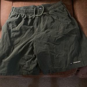 Men's green Reebok shorts.